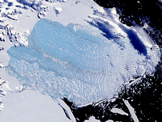 This image shows the aftermath of the Larsen Iceshelf collapse as seen by MODIS on 3/7/2002.
