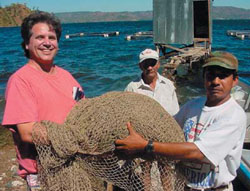 Photo: Louisiana environmental specialist Thomas Hyme works together with Salvadorian tilapia farmers as part of USAID Farrmer to Farmer program. 
