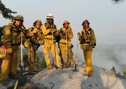 5 firefighters taking a break from fighting fires.