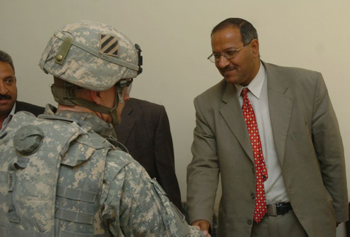 Col. Wayne W. Grigsby Jr., from Prince George's County, Md., the commander of the 3rd Brigade Combat Team (left), greets Judge Razak, the investigative judge for the Mada'in Qada (right), at the government center in Salman Pak, March 10. This was the first time judges had returned to Salman Pak since extremists forced them to leave three years ago. 