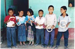 Maya K'iché schoolchildren in Quiché proudly display objects they made from recycled material.