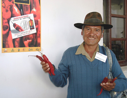 A farmer shows a sample of the chili peppers he sold at the International Red chili Pepper Festival in Padilla, Bolivia.