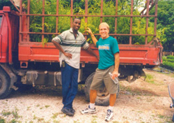 Partners Farmer to Farmer volunteer Norman Bezona and local coordinator Benito Jasmin transport bamboo plants in northern Haiti.