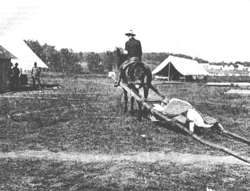 picture of man on horse pulling travois