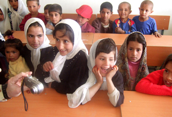 Afghan elementary school children crowd into class during the first day of school at Jan Qadam Elementary School, Parwan Province, March 24. Village elders, Ministry of Education officials and Coalition Soldiers gathered to celebrate the first day of school as well as dedicate the new school library and science lab. (U.S. Army photo by Staff Sgt. Marie Schult)