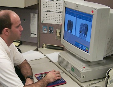 Photograph of Technician analyzing fingerprints