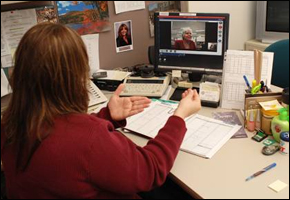 Photo of Trudy Ford, Sign Language Interpreter, helping a hearing impaired FBI
          employee communicate.