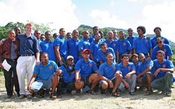 USAID and Peace Corps volunteers pose with members of the Damajagua River Guide Association after a training session.