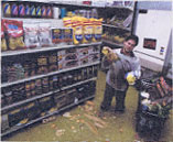 Image of a store owner who's grocery store is flooded
