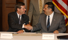 EPA Administrator Mike Leavitt and Secretary Abraham shake hands after signing the science research MOU.
