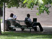 photo of college students sitting on a bench
