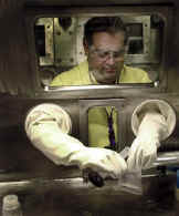 Secretary Abraham using a glovebox on April 19 visit to Los Alamos