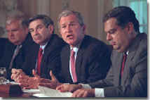 President Bush speaks to reporters during an Energy Meeting in the White House Cabinet Room, flanked by Secretary Abraham and Deputy Defense Secretary Paul Wolfowitz