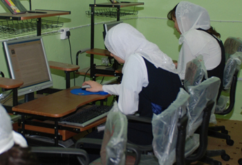 Students at the Al Kut girls secondary school use computers provided by the Wasit provincial reconstruction team March 10. The school's new Internet center features 10 new computers and furniture.