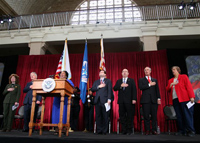 USCIS employee Shyconia Burden sings the National Anthem during the Ellis Island Naturalization Ceremony.