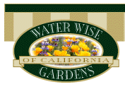 An oval logo displaying a beautiful array of poppies and purple flowers with a green ring around the oval displaying the text Water Wise Gardens. There is a gold ribbon running through the oval that reads of California.  The overall text reads Water Wise Gardens of California.