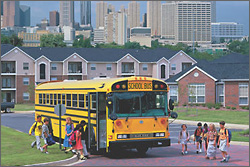 Photo of a school bus and children.