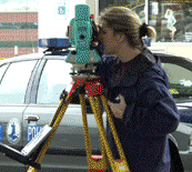 Photos of people working in the Special Projects Unit.  Below the photo display is a blue background with survey equipment at a crime scene in Virginia. This photo is faded in the background with white links on top of the image.