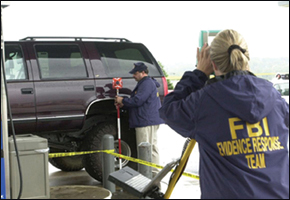 FBI evidence experts map the crime scene at one of the Beltway Snipers shootings.