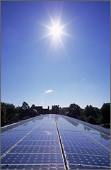 Photo of the sun striking photovoltaic panels.