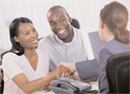 A man and woman shaking hands with a professional woman