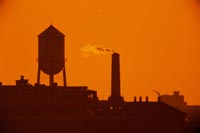 Emissions: The image representing this topic is photograph of smoke coming from a smokestack at sunset.