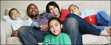 Photo: A family gathered on a couch