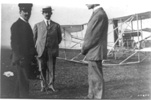 King Victor Emmanuel of Italy at left, with Orville and Wilbur Wright and their airplane, 1909