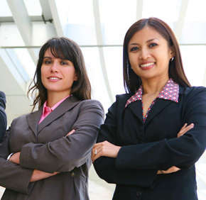 2 women in business suits smiling