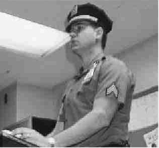 Photograph of police officer speaking at a podium