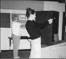 Photograph of two women firing hand guns at the citizen police academy