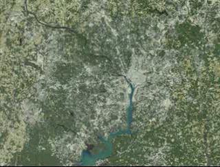 Starting with a view of the Washington, D.C., metropolitan area, the D.C. border and the Beltway fade in. The view then shifts to Waldorf, Maryland, indicating urban growth with red dots. Data sets for 1973, 1980, 1985, 1990, and 1996 are presented chronologically.