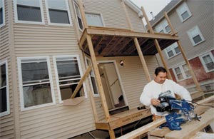 Jose Santiago repairing a porch in conjunction with a NeighborWorks® initiative in Providence.