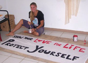 Igoe paints a banner for an HIV/AIDS presentation