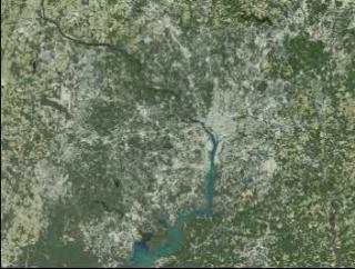 Starting with a view of the Washington, D.C., metropolitan area, the D.C. border and the Beltway fade in. The view then pushes in, indicating urban growth with red dots. Data sets for 1973, 1980, 1985, 1990, and 1996 are presented chronologically.