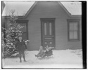  Milton Wright, Ivonette Wright, and Leontine Wright seated on sled.

