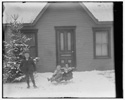  Milton Wright, Ivonette Wright, and Leontine Wright seated on sled. 

