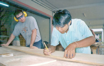 Volunteer Maxwell Chance works in a carpentry shop with one of his counterparts in Khao-lak, Thailand.