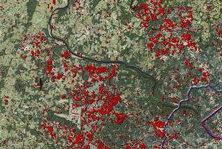 Using Landsat data to study Urban Sprawl.  In this image the red dots indicate areas of urban growth.