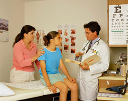 a girl with her mom and doctor