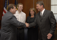 Public Printer Bob Tapella administers the oath of office to Deputy Public Printer Paul Erickson. Erickson’s son and wife, Clayton and Misty Erickson, look on.  The ceremony took place at the U.S. Government Printing Office in Washington, D.C.