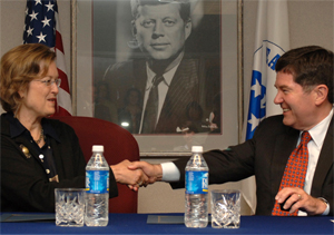 Peace Corps Deptuy Director Jody K. Olsen shakes hands with Knox college President Roger L. Taylor during the signing ceremony at the Peace Corps Headquarters in Washington, D.C.
