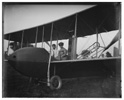  Katharine Wright, wearing a leather jacket, cap, and goggles, aboard the Wright Model HS airplane with Orville, 1915 
