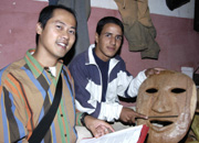 Volunteer Nam LaMore and a local artisan show a carving from the wood working cooperative.