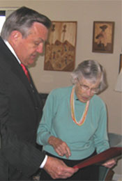 Director Tschetter looks over memorabilia with oldest living Peace Corps Volunteer Evangeline Shuler.