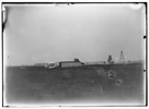  Start of the first flight of 1905, Orville Wright at controls ofthe machine, near the hangar at Huffman Prairie. The two figures in the center are probably Wilbur Wright and Charles E. Taylor. The catapult launching device appears for the first time in a photograph.


