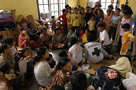 Representatives from the United Nations and the World Health Organization converse with Indonesian nationals living at a camp located in the town on Alue Bilie, Aceh.  U.S. Navy photo by Photographer's Mate 2nd Class Elizabeth A. Edwards.