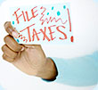 A woman holding a sign that says 'FILE TAXES.'