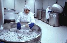 lab worker handling tissue samples in liquid nitrogen freezers