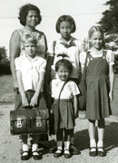 Lesley and Martha Duncan in school uniforms with neighbors.